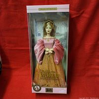 Full view of Barbie doll in original collector edition packaging, showing pink and gold medieval-style gown and detailed packaging design.