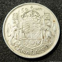 Reverse side of the 1943 Canada 50 cents silver coin showing Canadian coat of arms, denomination, and year.