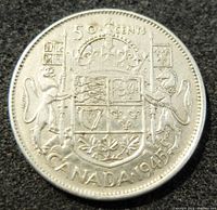 Reverse side of the 1945 silver Canada 50 cents coin showing the crowned shield of the Canadian coat of arms and the denomination/year.