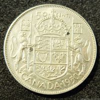 Reverse side of the 1950 Canadian silver 50 cents coin featuring the Canadian Coat of Arms with denomination and year.