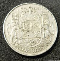 Reverse side of 1950 Canada 50 cents silver coin showing the Canadian coat of arms with two animals, flags, crown, denomination, and year.