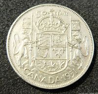Reverse of the 1951 Canadian 50 cents silver coin showing Canadian coat of arms with crown, lion, unicorn, and text