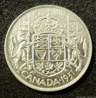 Reverse side of the 1951 Canadian 50 cents silver coin featuring the Canadian coat of arms with lion and unicorn supporters.