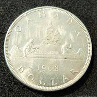 Reverse side showing canoe voyageur design, Northern lights, and inscription.