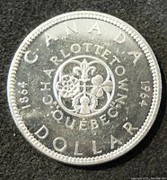 Reverse side of the 1964 Canadian silver dollar coin showing the floral emblem design and inscriptions.