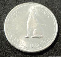 Reverse side of the 1967 Silver Canada 50 Cents Coin depicting a howling wolf and inscriptions including '50 CENTS', 'CANADA', and '1867-1967'.