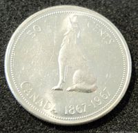Reverse side of the 1967 Canadian silver 50 cents coin showing a howling wolf with inscriptions and date 1867-1967.