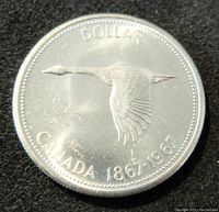 Obverse side with flying Canada goose and inscriptions.