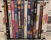 Line-up view of 15 DVD movie cases showing titles and spine art.