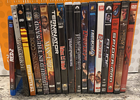 Photo showing the 17 movie DVDs arranged vertically side by side, titles visible on spines