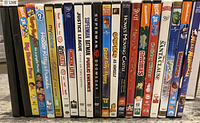 Photo showing the DVD spines of 21 movies including Nick Jr., Hoodwinked, Justice League, Superman Batman, Garfield, and others.