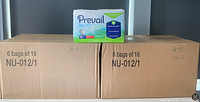 Two cardboard boxes each containing 6 bags of Prevail Nu-Fit Daily Briefs packaged inside, with one single bag placed on top for display.