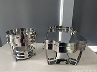 Round stainless steel welded chafing dish frame with integrated fuel holders seen from front and side angle