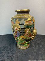 Front-left view showing raised high-relief immortal figure in traditional attire with scenic surroundings