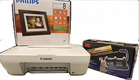 Canon white printer, Philips digital photo frame box, and OIC 3 hole punch box together on table.