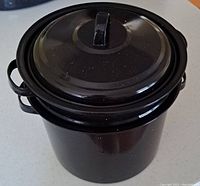 Black enamel canning pot with matching lid seen from above