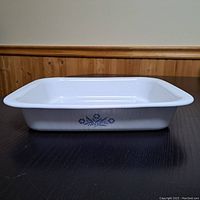 Side view of white ceramic rectangular baking dish with vintage Blue Cornflower pattern on side.