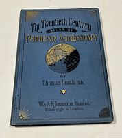 Front cover showing blue hardcover with gold and black embossing, book title and author by Thomas Heath, with some corner wear and fading.