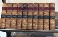 Full set of 10 antique leather bound Waverley Novels by Sir Walter Scott, spine view showing gold embossing and volume titles.
