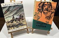 Front covers of both books on easels showing dust jackets and illustrations.