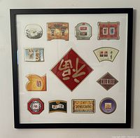 Square view of the full framed display with all twelve zodiac-themed stamp cutouts arranged around a central red diamond with Chinese calligraphy.