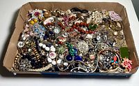 Overview shot showing entire box filled with assorted jewelry pieces