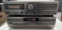Front view of JVC stereo surround system receiver and 5 disc CD player stacked.