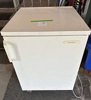Front exterior view of the white Kenmore under counter refrigerator showing the door and handle.