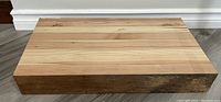 Front view of the large rectangular pine butcher block showing wood grain and surface condition.