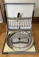 Full view of set including round cake plate in base and 12 forks with server in lid of original box