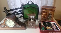 Wide view showing the entire mixed lot including clocks, tray, jewelry box, wine rack and figurines