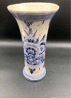Front view of blue and white ceramic vase showing floral pattern and flared rim.
