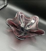 Front view of burgundy glass decorative bowl showing shape and color