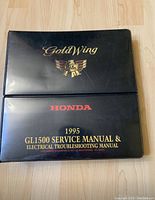 Black binder titled 1995 Honda Gold Wing GL1500 service manual and electrical troubleshooting manual.