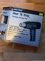 Box of Black & Decker Heat 'N Strip flameless heating tool with product information and heat settings.