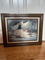 Frontal image of the framed winter scene painting showing the tipi tent and snow with visible signature