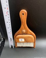 Photo of two wooden cleaning brushes including a hand brush and a dustpan brush with a ruler for scale showing approximately 7.5 inches in length.
