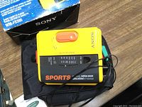 Yellow Sony Sports Walkman FM/AM radio cassette player with box and earphones