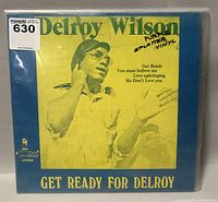Front cover of the vinyl record showing Delroy Wilson and album title with note 'Purple Splatter Vinyl'.