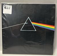 Front cover of Dark Side Of The Moon vinyl record featuring prism and rainbow artwork.