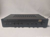 Front view of Rotel RA-820A amplifier showing all control knobs, switches, and indicators. Minor surface scratches visible.