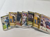 Photo shows multiple volumes of Ballstreet Journal baseball card price guides lined in plastic cases. Covers show various baseball player action images from 1991-92 editions.
