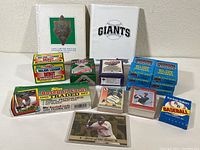 Full view of lot including multiple unopened baseball card boxes, binders, and a loose holographic card in protective sleeve