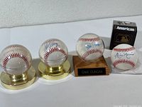 Four autographed baseballs shown together: Tommy Davis, Bill Moore, Dave Duncan, Mike Harris (in box).