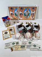 Full lot of Oakland A’s memorabilia including boxed autographed baseballs, tickets, medalions, pins, and posters.