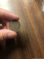 Reverse image of the 1917 Canadian penny showing denomination, date and wreath design.