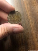 Reverse side of 1918 Canadian one cent coin showing denomination, year, and decorative border.