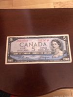 Front side of the 1954 Canadian five dollar bill showing the queen's portrait and serial numbers.