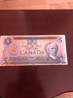 Front of 1979 Canadian five dollar bill showing Sir Wilfrid Laurier portrait and denomination details.