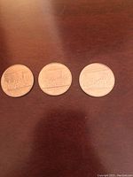 Three 1982 Canadian silver dollars visible on table, reverse side showing Confederation design.